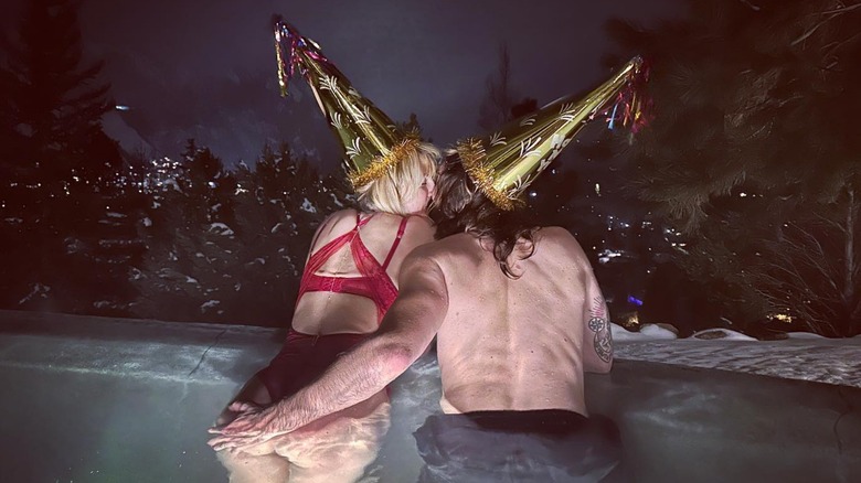 Heidi Klum kissing Tom Kaulitz in a pool