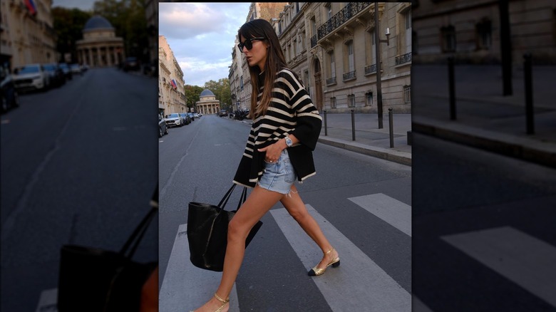 A woman crossing the street in Paris