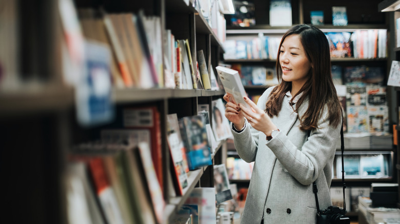 Asian woman browsing books at a bookstore