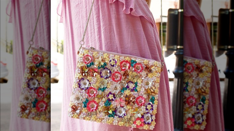 Floral bag hanging off side of dress