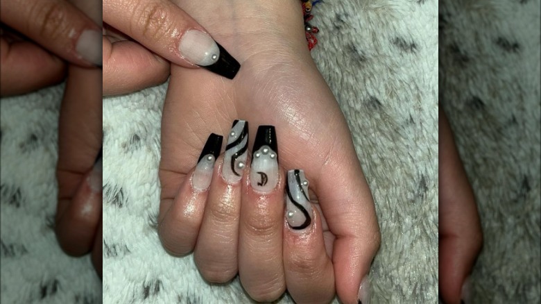 Black nail art with pearls