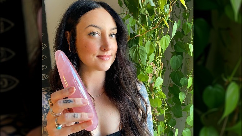 Woman holds a Le Wand sex toy