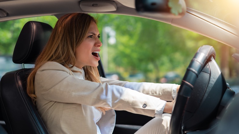 Woman honking her horn in anger 