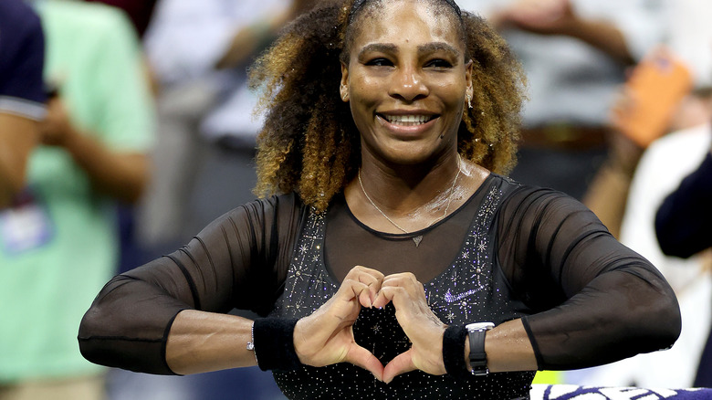 Serena Williams making a heart with hands and smiling