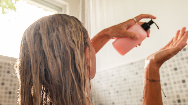 Woman applying shampoo