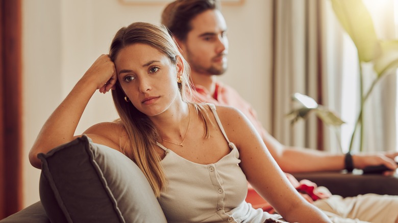 worried woman back turned to man