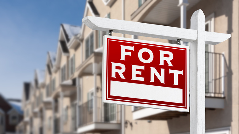 A rental sign in front of houses