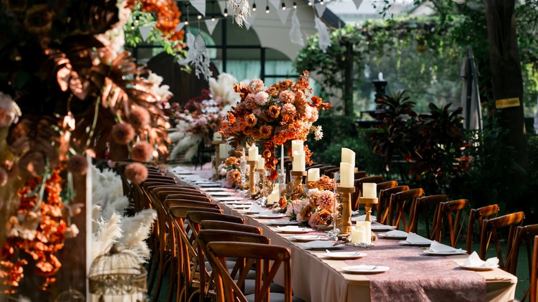 An orange and pink themed wedding reception table