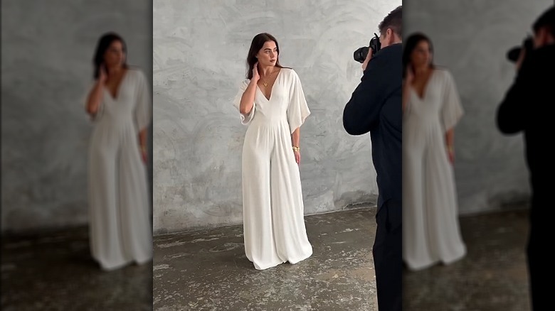 Model wearing bridal jumpsuit being photographed