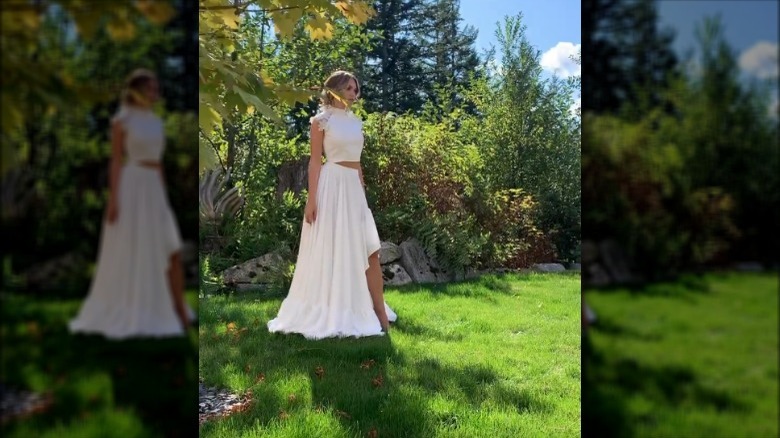 Bride in a two-piece set on lawn