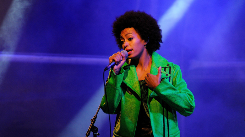Solange Knowles on stage with a mic