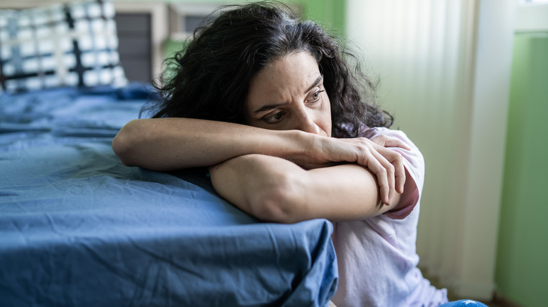 Depressed woman edge of bed