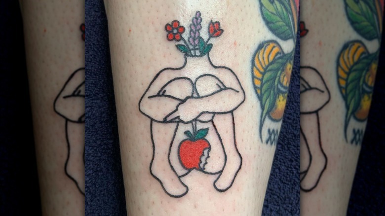 An apple and body tattoo