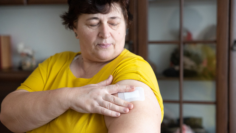 woman putting on patch