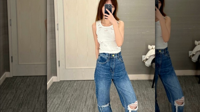 woman posing with ripped jeans