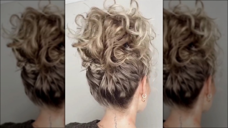 Woman with a curly claw clip updo