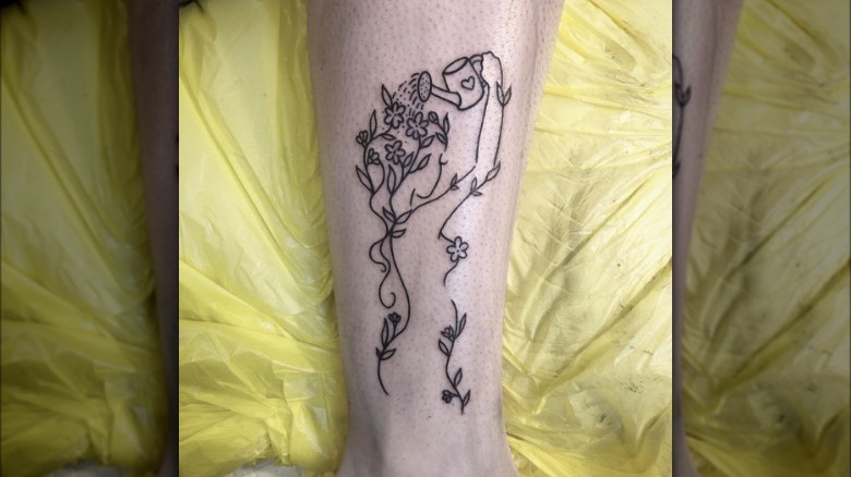 Woman watering her own flowers tattoo