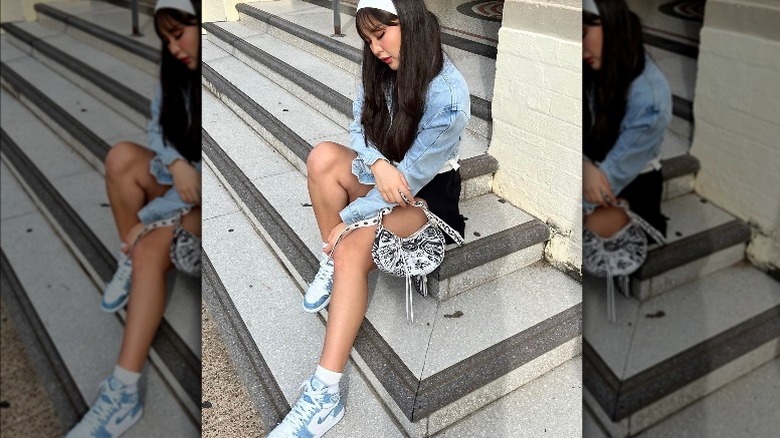 woman wearing jean jacket and sneakers