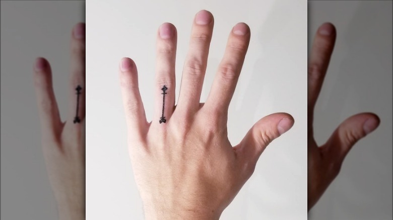Arrow finger tattoo
