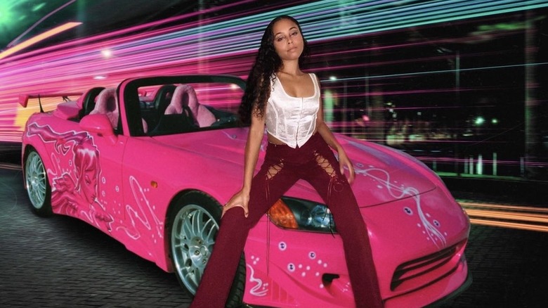 woman posing in front of pink car Suki costume