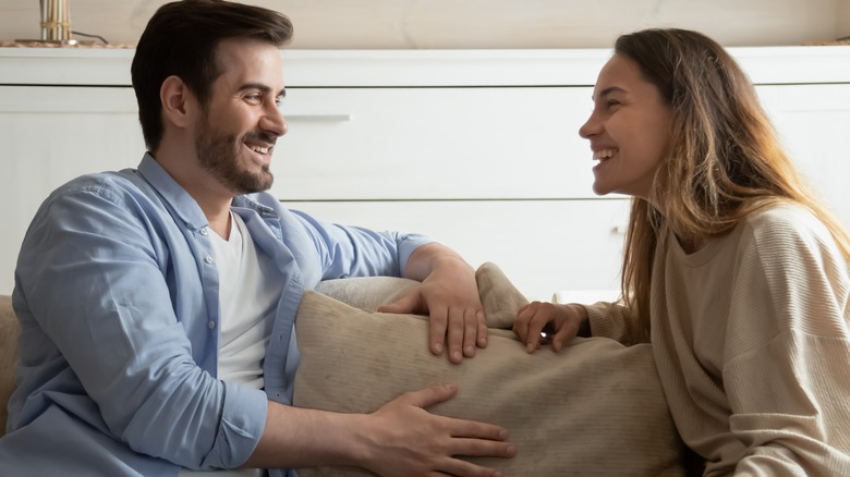 Couple laughing on couch