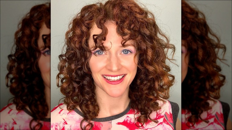 Woman with curls and bangs