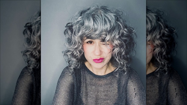 Woman with curly bangs