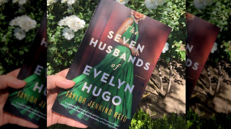 Hand holding "The Seven Husbands of Evelyn Hugo"