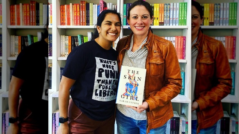 Sarah Cypher holding her book with fan