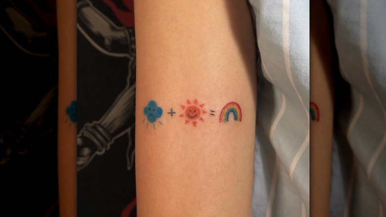 Cloud, sun, and rainbow tattoo
