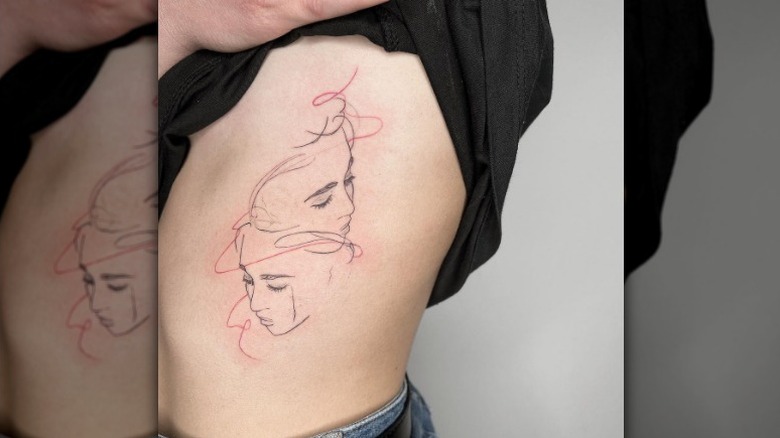 Two faces tattoo