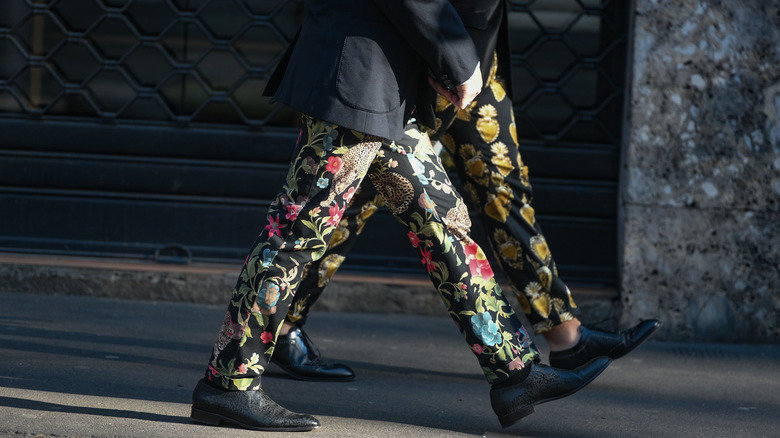 two people with printed pants