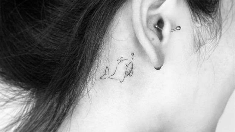 Whale tattoo behind the ear