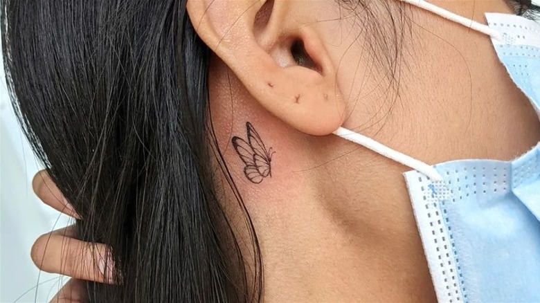 Butterfly behind the ear tattoo