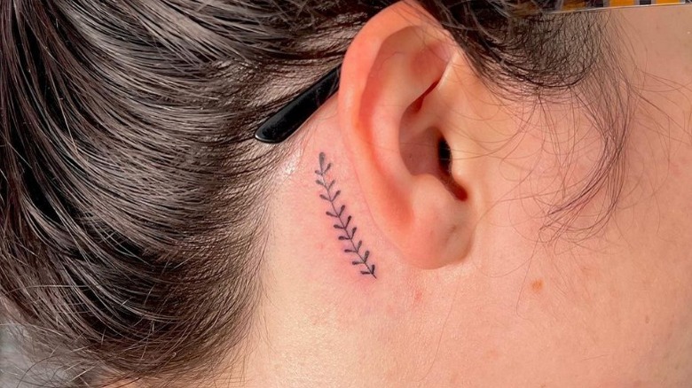Leaf stem tattoo behind the ear