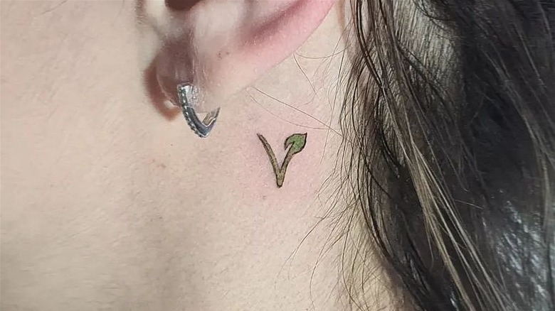 Vegan behind the ear tattoo