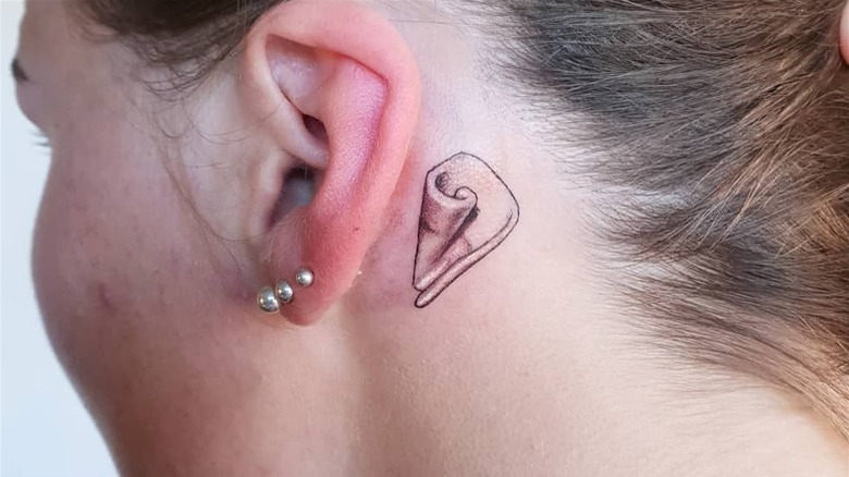 Shell tattoo behind the ear