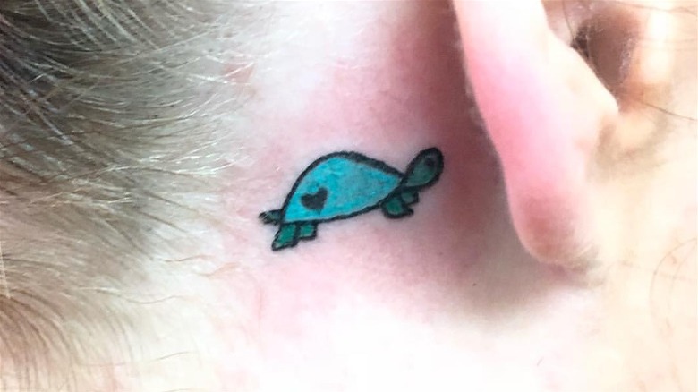 Turtle behind the ear tattoo