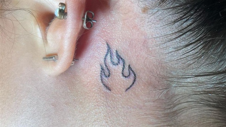 Behind the ear flame tattoo