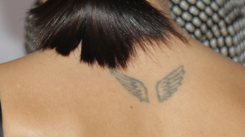 Tattoo of angel wings on woman's back