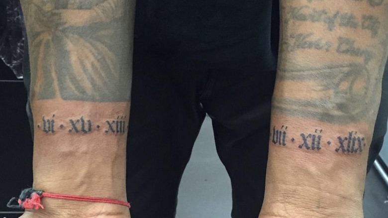 Kanye West with dates tattooed on wrists