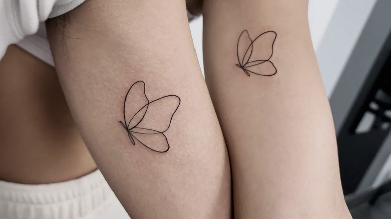 matching butterfly tattoos on two arms