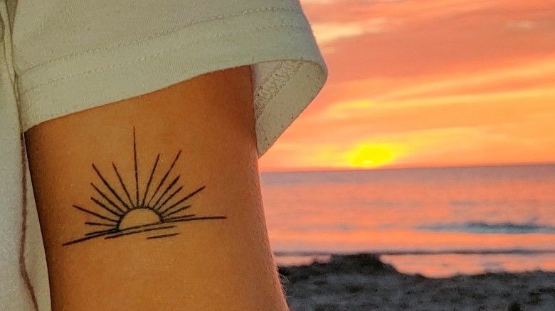 Sunset tattoo next to actual sunset