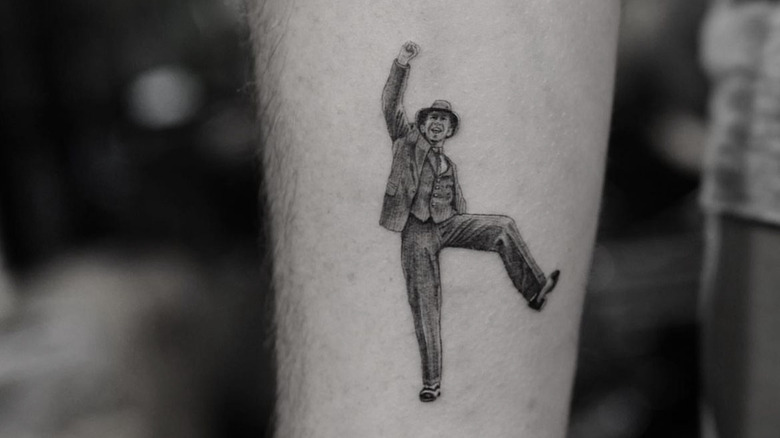 tattoo of dancing man wearing a suit