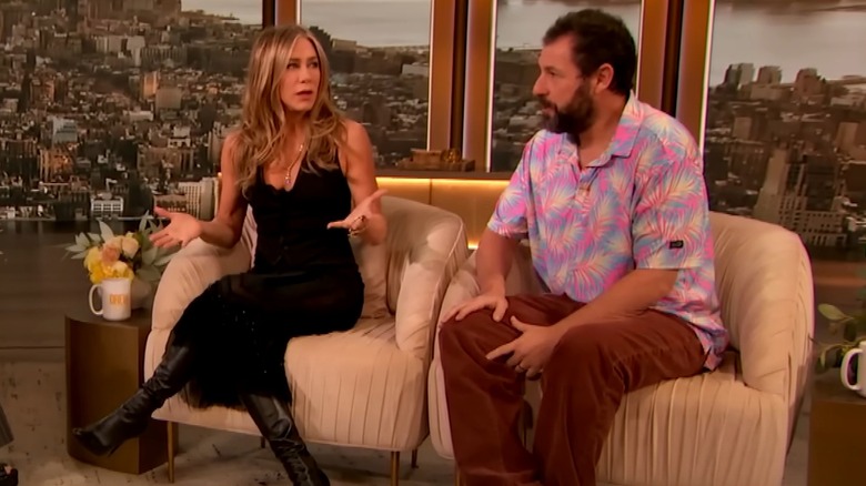 Jennifer Aniston wearing a vest with Adam Sandler