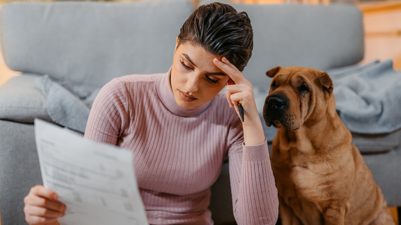Woman looks at financial paperwork