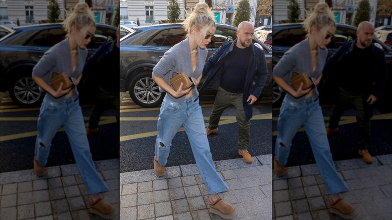 Paparazzi shot of Gigi Hadid wearing Ugg clogs with blue jeans