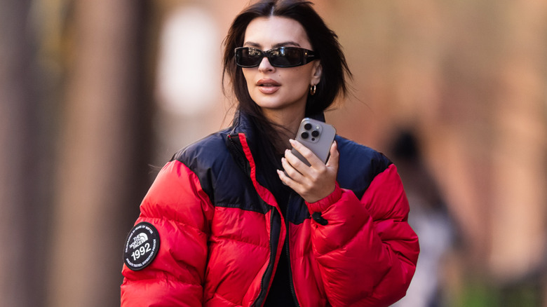 Emily Ratajkowski walking in New York in a red puffer coat