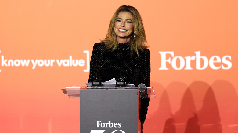 Shania Twain standing at a podium