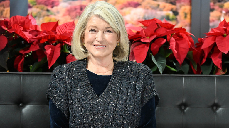 Martha Stewart in front of poinsettias